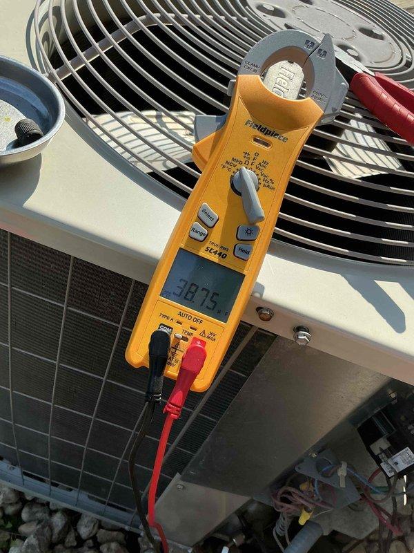 Completed comprehensive BFMA tune-up on 6+ year old HVAC system as first call of the day. Performed electrical diagnostics on outdoor condensing unit using clamp meter, recording amperage readings of 30.75 amps to verify proper compressor operation and system performance. Inspected condenser coil, fan assembly, and all exterior components, confirming unit operational status with no visible defects or required repairs.