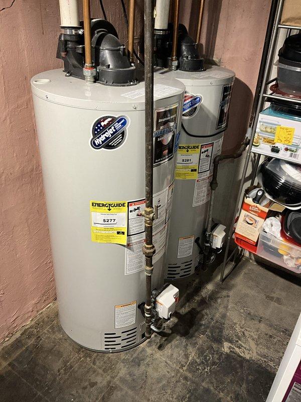 Responded to emergency call for flooded basement with 3-4 inches of standing water. Diagnosed dual water heater system where one unit displayed 7-flash error code indicating failure. Inspected both tanked water heaters, evaluated piping connections, drainage systems, and electrical components. Documented equipment condition including water damage to concrete floor and identified malfunctioning unit requiring repair or replacement to restore hot water service to the residence.