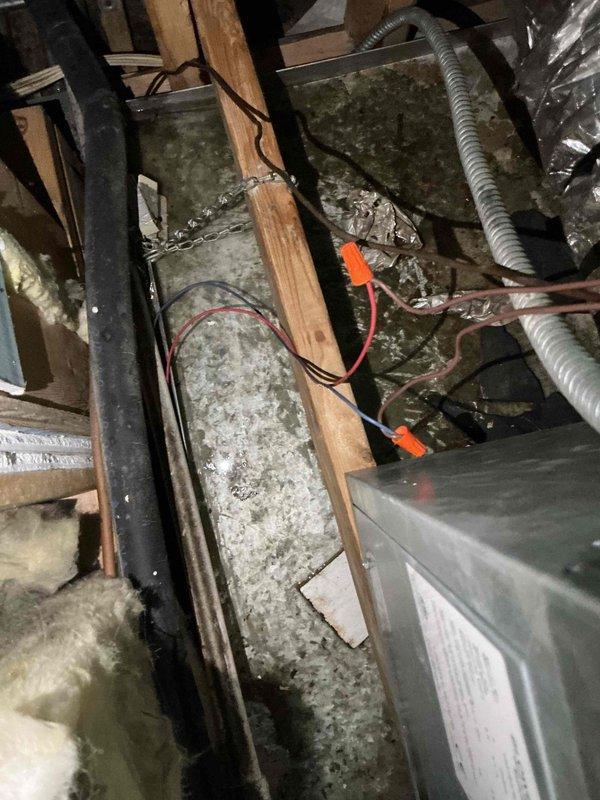 Responded to service call for reported air conditioning leak from third floor to second floor. Upon arrival, customer indicated leak had stopped but requested system inspection. Accessed attic space and inspected HVAC ductwork and air handler unit. Observed dust accumulation on metal ductwork and components throughout mechanical space. Examined drain lines, condensate system, and air handler for signs of active leakage or moisture intrusion. Verified all electrical connections and wire junctions in vicinity of HVAC equipment. Documented existing conditions with photographs of attic installation and exterior building structure. No active leaking observed during inspection. System operational at time of service.