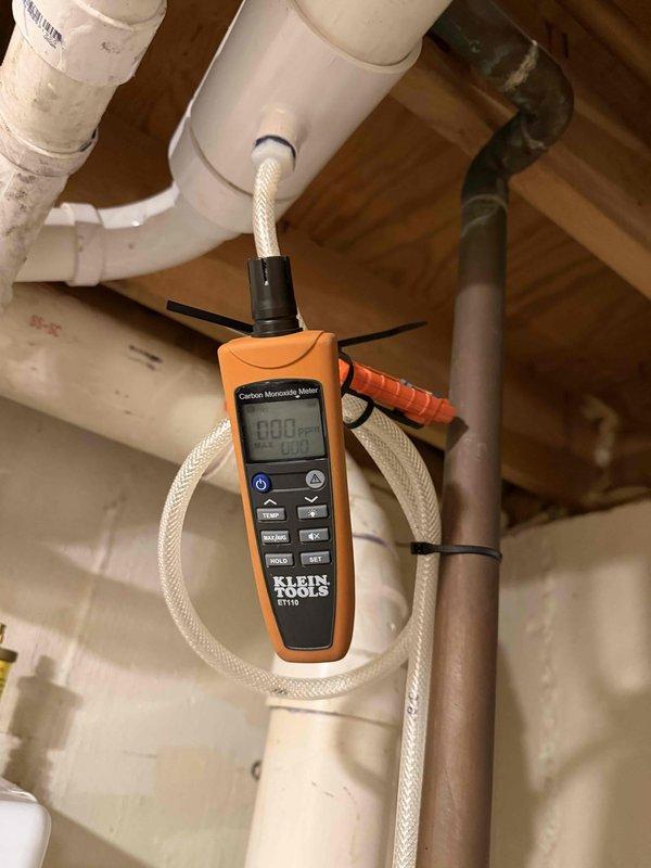 Responded to customer report of carbon monoxide detection from Navien boiler system. Upon arrival, performed comprehensive carbon monoxide testing throughout the mechanical space and at the boiler unit using calibrated Klein Tools CO meter. Testing confirmed zero parts per million (0 ppm) carbon monoxide present in the area and at all exhaust points. Inspected PVC venting system, flue connections, and combustion air supply for proper installation and clearances. All components found to be functioning within normal parameters with no evidence of CO production or venting issues.