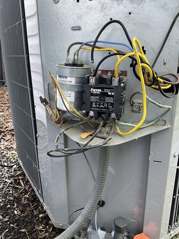 Responded to no cooling call following recent maintenance visit. Upon inspection of outdoor unit electrical compartment, identified failed dual-run capacitor as cause of system failure. Replaced defective MICO capacitor with new unit, verified all electrical connections at contactor and capacitor terminals, and tested system operation. Unit restored to proper cooling function with compressor and condenser fan motor operating within normal parameters.
