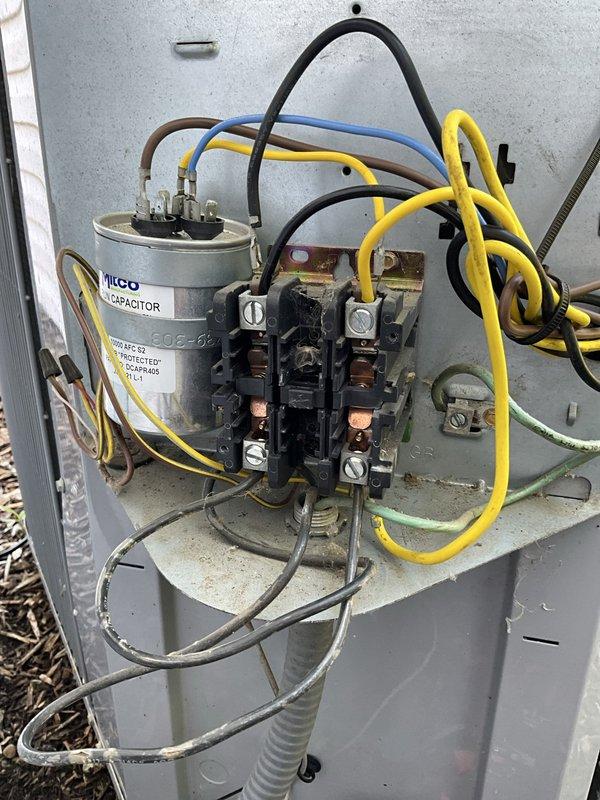 Responded to no cooling call following recent maintenance visit. Upon inspection of outdoor unit electrical compartment, identified failed dual-run capacitor as cause of system failure. Replaced defective MICO capacitor with new unit, verified all electrical connections at contactor and capacitor terminals, and tested system operation. Unit restored to proper cooling function with compressor and condenser fan motor operating within normal parameters.