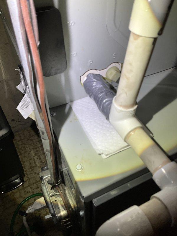 Responded to call back for water leak at furnace. Upon arrival, found PVC condensate drain pipe had snapped at connection point near furnace unit, causing active water leakage from condensate drainage system. Implemented temporary repair by securing broken PVC connection to restore drainage function and stop immediate leak. Documented equipment condition and repair with photos for follow-up permanent repair scheduling.