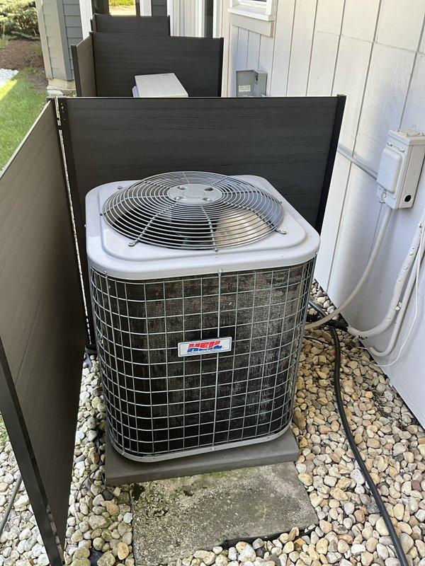 Completed comprehensive BFMA tune-up on 14-year-old Heil air conditioning condenser unit located in side yard enclosure. Performed standard preventative maintenance protocol including system inspection, cleaning of heavily soiled condenser coils which exhibited significant accumulation of dirt, dust, and debris throughout the fin surfaces, and verification of proper operation. Unit was found to be operational with protective wire mesh cage intact and equipment properly positioned on concrete pad with adequate ventilation clearances maintained within privacy fence enclosure.