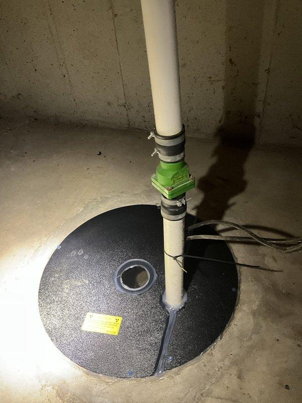Responded to service call regarding failed sump pump system. Upon inspection, confirmed sump pump requires complete replacement due to malfunction. Unit is located within radon mitigation system configuration, which will need to be carefully considered during replacement to maintain proper radon system operation. Documented existing installation showing PVC discharge piping with coupling connections and basin cover assembly. No further testing performed at this time pending replacement authorization.