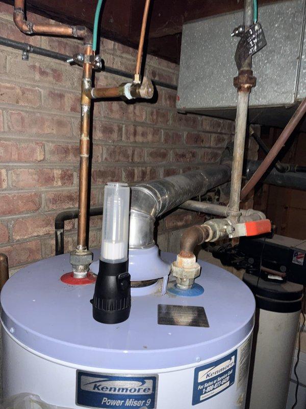 Responded to no hot water complaint following recent storm activity. Performed diagnostic inspection of Kenmore Power Miser 9 tanked water heater located in basement utility area. Assessed electrical connections, plumbing connections, temperature and pressure relief valve, and heating elements to determine cause of failure and restore hot water service to residence.
