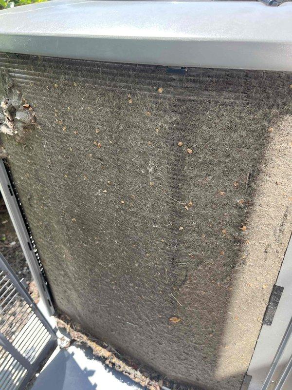 Completed comprehensive BFMA tune-up on residential air conditioning system. Upon arrival, found outdoor condenser unit with severely clogged air filter screen heavily contaminated with dirt, dust, leaves, and organic debris that was significantly restricting airflow and reducing system efficiency. Removed and cleaned filter assembly, removing all accumulated material from mesh surface. Performed standard AC maintenance protocol including inspection of condenser coils, verification of refrigerant lines, electrical connections, and disconnect box functionality. Unit tested and confirmed operating within normal parameters following service completion.