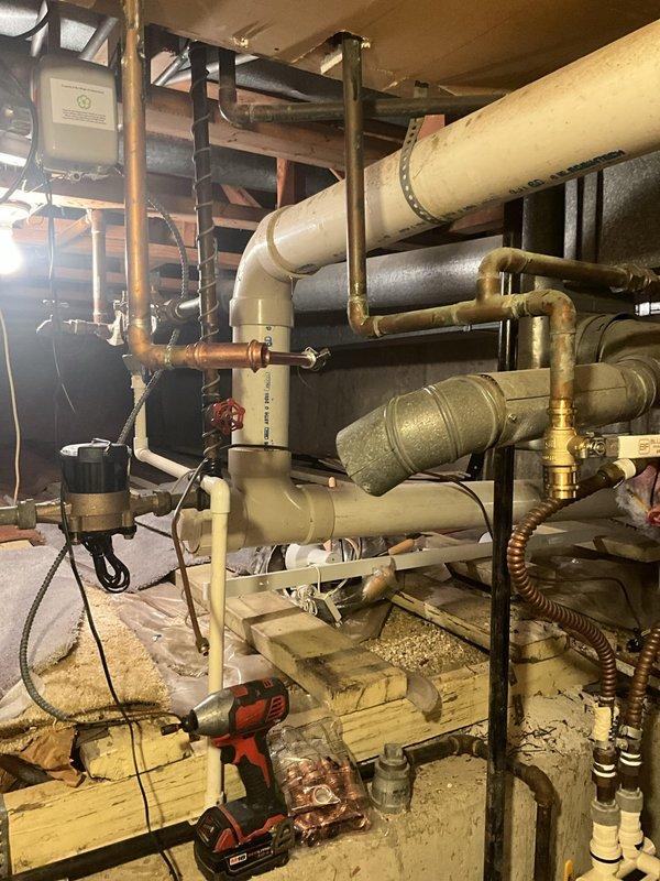 Completed residential water heater installation in basement utility area as part of full system package. Installed new standard capacity tanked water heater with proper copper piping connections, ensuring all supply and discharge lines were securely fitted and code-compliant. Integrated unit with existing plumbing infrastructure including water softener system, verified all connections for proper operation and tested system functionality upon completion.