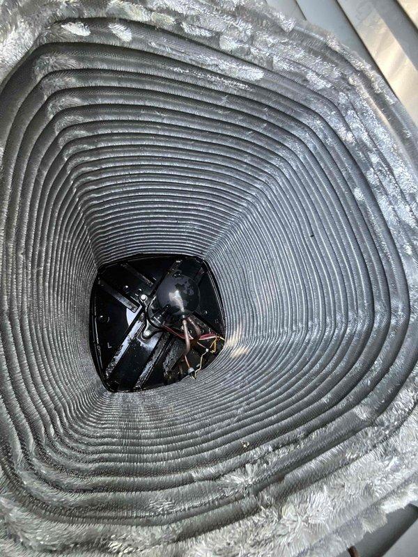 Completed comprehensive BFMA tune-up service on residential air conditioning system with one-year-old equipment. Performed standard maintenance protocol including inspection of outdoor condenser unit, verification of electrical connections and disconnect box, and examination of interior ductwork components. Observed moderate dust accumulation within coiled ductwork assembly and routine weathering on exterior condenser fins, with all mechanical components functioning within normal parameters upon completion of tune-up procedures.