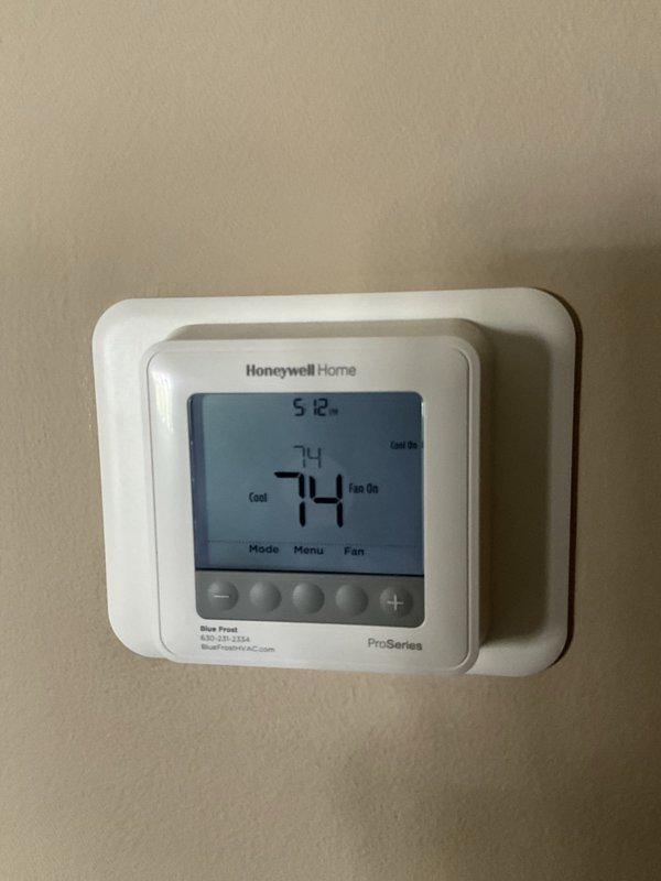 Completed comprehensive BFMA tune-up on residential air conditioning system aged 3+ years. Upon inspection, discovered significant frost and ice accumulation on evaporator coil and plenum assembly, indicating restricted airflow or potential refrigerant charge issues. Verified thermostat operation showing system set to 74°F in cooling mode with fan running continuously. Performed standard maintenance protocol including filter inspection, coil cleaning, refrigerant level assessment, and airflow evaluation to address freezing condition and restore proper system operation.
