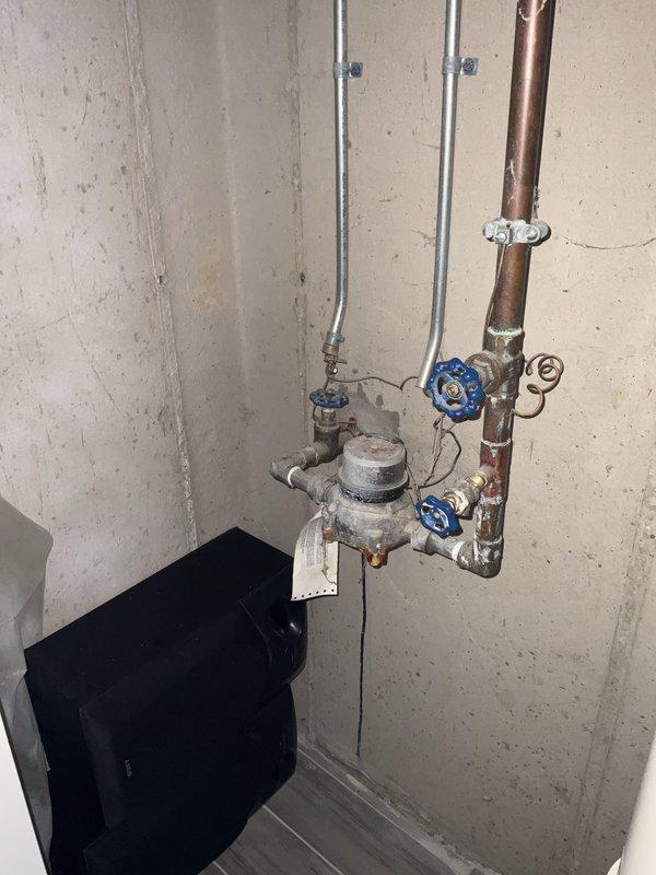 Completed comprehensive plumbing inspection for landlord, documenting water supply system including main shutoff valves, water meter assembly, and vertical drainage piping. All copper supply lines, galvanized pipes, gate valves, and PVC drain stack with cleanout fitting were photographed and assessed for proper operation and condition.