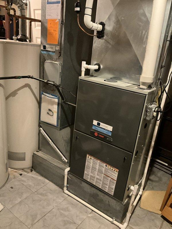 Completed comprehensive BFMA tune-up service on residential HVAC system including 7+ year old Trane air conditioning unit and furnace. Performed standard maintenance procedures including inspection of all mechanical components, verification of proper refrigerant levels, cleaning of condensate drain lines, testing of thermostat programming and system response, and evaluation of overall system performance. System operating within normal parameters with thermostat displaying 77°F indoor temperature in cooling mode, 86°F outdoor temperature, and 53% indoor humidity level at time of service completion.