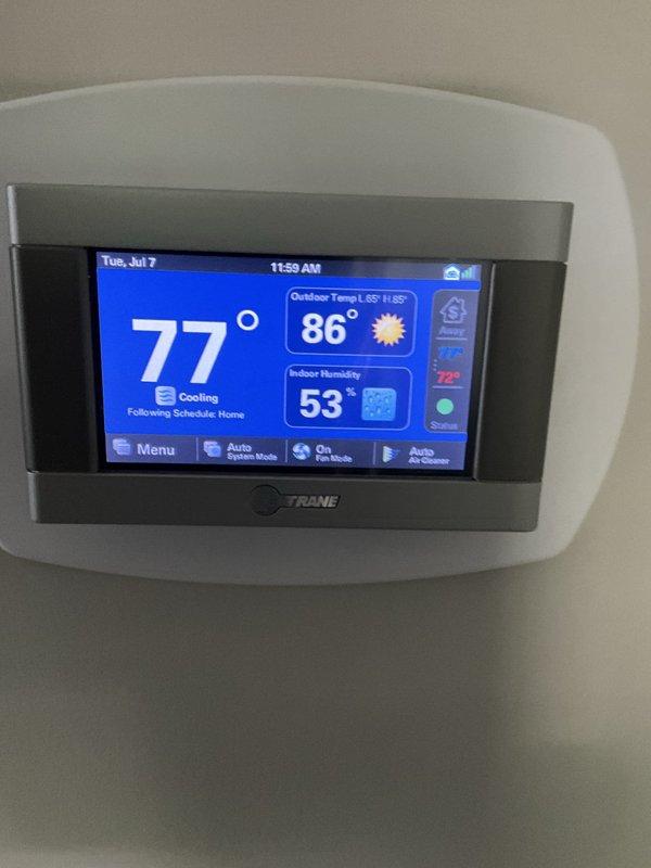 Completed comprehensive BFMA tune-up service on residential HVAC system including 7+ year old Trane air conditioning unit and furnace. Performed standard maintenance procedures including inspection of all mechanical components, verification of proper refrigerant levels, cleaning of condensate drain lines, testing of thermostat programming and system response, and evaluation of overall system performance. System operating within normal parameters with thermostat displaying 77°F indoor temperature in cooling mode, 86°F outdoor temperature, and 53% indoor humidity level at time of service completion.