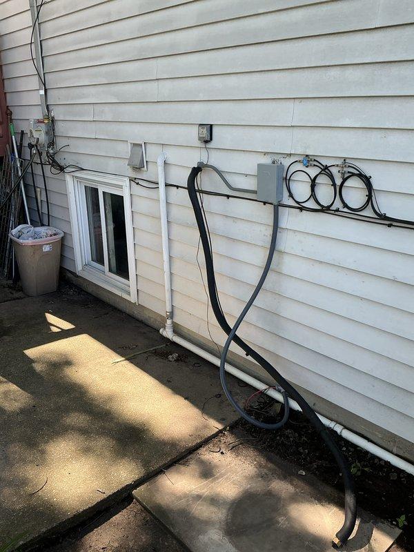 Conducted comprehensive HVAC system evaluation for residential property requiring air conditioning and evaporator coil replacement estimate. Assessed exterior utility area where existing AC condenser unit connects to home's electrical service and refrigerant line sets. Documented current equipment configuration including electrical connections, conduit routing, and concrete pad condition for outdoor unit placement. 

Inspected unfinished basement mechanical space to evaluate indoor furnace and evaporator coil accessibility. Examined existing ductwork distribution system, including flexible supply ducts and air distribution infrastructure. Assessed clearances around furnace cabinet and available workspace for coil replacement procedures. Documented electrical service routing, support structures, and mechanical room layout to determine installation requirements and system compatibility for proposed equipment upgrade.