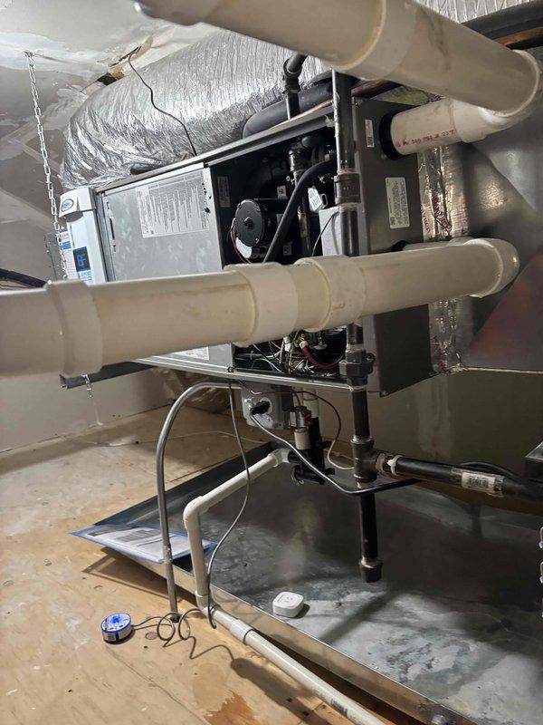 Responded to service call for air conditioning unit that had shut down due to condensation overflow triggering the safety float switch. Upon inspection, found excessive moisture accumulation in the drain pan causing the system to trip. Performed temporary repair by blow-drying the affected components to remove moisture and restore immediate operation. Cleared condensate blockage and verified unit returned to normal cooling function with 88°F supply air temperature. System restarted successfully after moisture remediation.