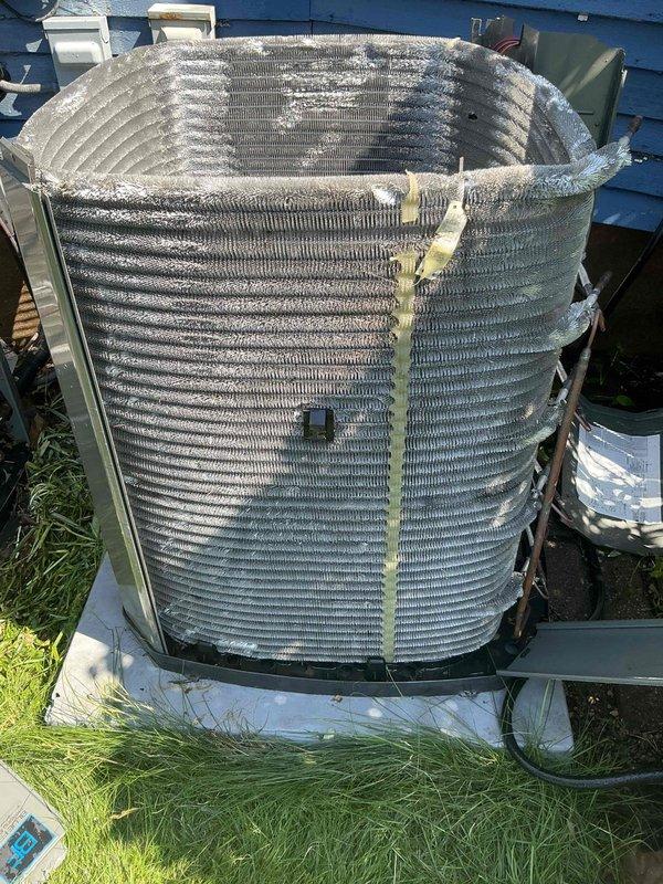 Completed comprehensive BFMA preventative maintenance tune-up on residential air conditioning system with cylindrical condenser coil configuration. Inspected outdoor condenser unit, noting moderate accumulation of dirt and debris on aluminum fins and coil surfaces consistent with normal outdoor operation. Performed standard maintenance procedures including system performance evaluation, component inspection, and documentation of unit condition showing typical weathering for equipment age range of 2-5+ years.