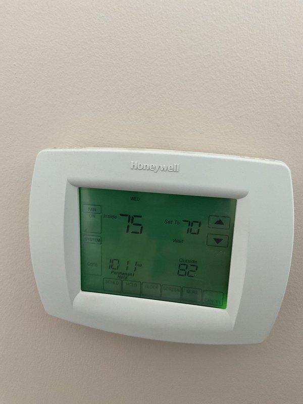 Completed comprehensive BFMA tune-up service on 14+ year old Lennox furnace and air conditioning system during morning appointment window. Performed full AC tune-up including system inspection, verified thermostat operation (Honeywell programmable unit displaying proper temperature readings and functionality), inspected all mechanical components in basement installation, checked air filter access, and evaluated ductwork and PVC condensate drainage system. All equipment found in clean operational condition with proper manufacturer labeling and safety information intact.