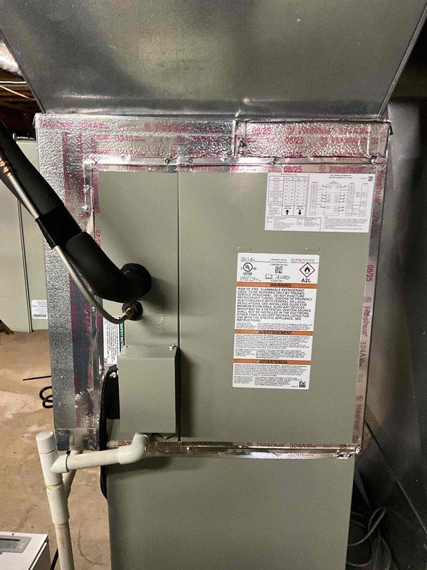 Completed installation of Trane air conditioning system including 5TTR5042A1000 condensing unit and 5PXCC005AS3HA evaporator coil. Integrated new equipment with existing furnace infrastructure, established refrigerant lines and drainage connections, and reinstalled thermostat to ensure proper system communication and climate control functionality.