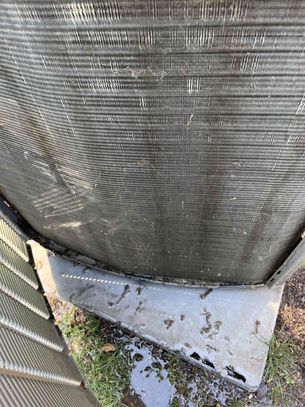 Completed BFMA preventative maintenance tune-up on 15-year-old air conditioning system that was rescheduled from previous date due to no cooling complaints. Upon arrival, performed comprehensive inspection of outdoor condensing unit, which showed normal weathering and debris accumulation on top mesh grille and concrete pad. Indoor inspection revealed significant frost buildup on air handler or evaporator coil assembly, indicating restricted airflow or potential refrigerant issue contributing to the original no cooling concern. Documented equipment condition with photographs showing outdoor unit condition and extensive frosting on indoor components for service records and follow-up recommendations.