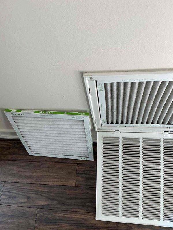 Performed comprehensive air conditioning tune-up on residential HVAC system over two years old. Accessed and inspected return air filter, which showed moderate dust accumulation and discoloration indicating normal use since last replacement. Examined evaporator coil assembly, noting dust and debris buildup on aluminum fins with some heavier accumulation in certain areas. Completed standard maintenance protocol including system inspection, filter evaluation, and coil assessment to ensure optimal cooling performance and efficiency.
