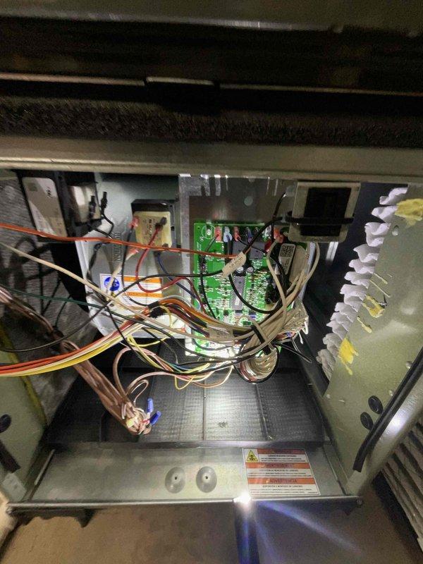Completed comprehensive BFMA tune-up on a 5-year-old air conditioning system, including full system inspection and preventive maintenance. Inspected air handler unit, verified proper operation of control boards and electrical connections, examined blower motor assembly with digital controls, and confirmed all wiring connections were secure. Assessed pleated air filter condition within the metal frame housing and inspected interior components for optimal performance and efficiency.