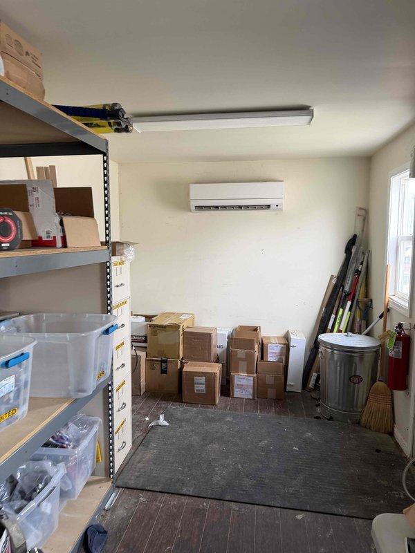 Conducted site assessment for commercial RTU replacement at facility with existing ductless mini-split system in storage area. Documented current equipment configuration including control module and circuit board assembly, photographed installation conditions, and gathered specifications for new rooftop unit estimate preparation.