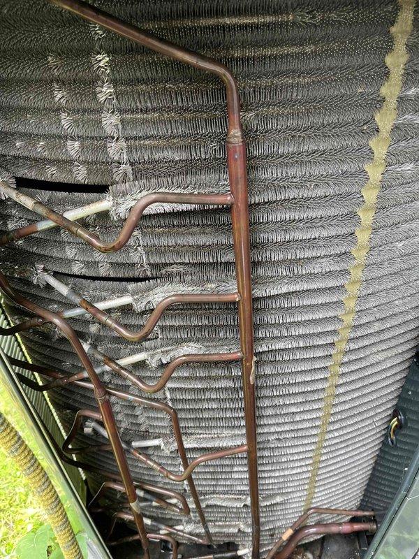 Completed comprehensive BFMA tune-up on 8+ year old air conditioning system. Inspected evaporator coil assembly, which showed oxidation on copper refrigerant lines and moderate accumulation of dust and debris throughout the finned structure; assessed outdoor condensing unit condition noting weathering consistent with system age. Replaced air filter with new pleated media filter to maintain proper airflow and system efficiency.
