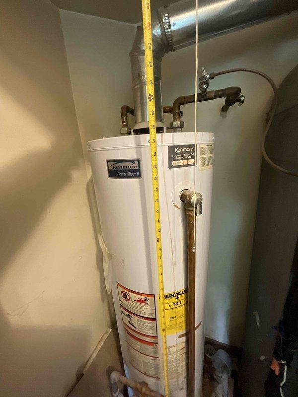 Responded to no cooling call at residential property. Upon arrival, performed diagnostic inspection of HVAC system and related mechanical equipment in utility area. Measured and documented existing water heater and HVAC components, including ductwork configuration and equipment spacing. Photographed installation for service records showing water heater, gray HVAC unit with insulation, metallic ventilation ductwork, and plumbing connections. Coordinated service visit during caregiver availability window to ensure property access and customer communication.