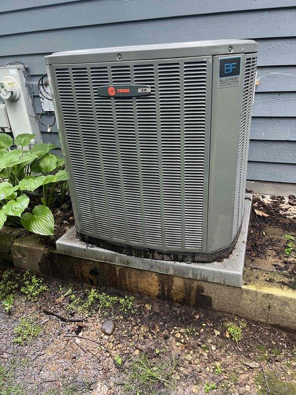 Completed comprehensive BFMA tune-up on Trane XR air conditioning system aged 3+ years. Inspected outdoor condenser unit, verified proper operation of all components, and checked electrical disconnect. Documented heavily contaminated air filter with significant dust and debris accumulation throughout pleated media, indicating need for replacement to maintain optimal system efficiency and indoor air quality.