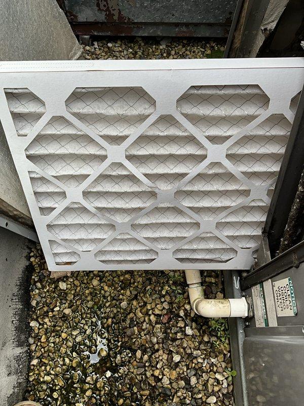 Responded to no cooling call for lunchroom air conditioning unit in commercial factory setting. Upon arrival, inspected rooftop condenser unit and evaporator coil located above breakroom. Performed diagnostic testing of electrical control panel and safety components, including rollout switches and thermal devices. Identified and replaced dirty air filter with new pleated media filter. Verified proper electrical connections, tested system operation, and confirmed unit returned to normal cooling function.