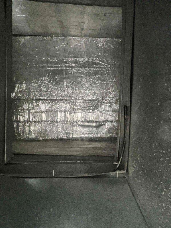 Completed comprehensive BFMA tune-up service on 13+ year old HVAC system as first call of the day. Performed furnace inspection and maintenance procedures including interior air handler examination, confirming proper insulation integrity and duct board condition. Serviced outdoor condenser unit by removing top panel for access, inspecting compressor and refrigerant lines, and clearing significant accumulation of organic debris including leaves and palm fronds from base of unit to ensure proper airflow and system efficiency. All components inspected, cleaned, and confirmed operational.