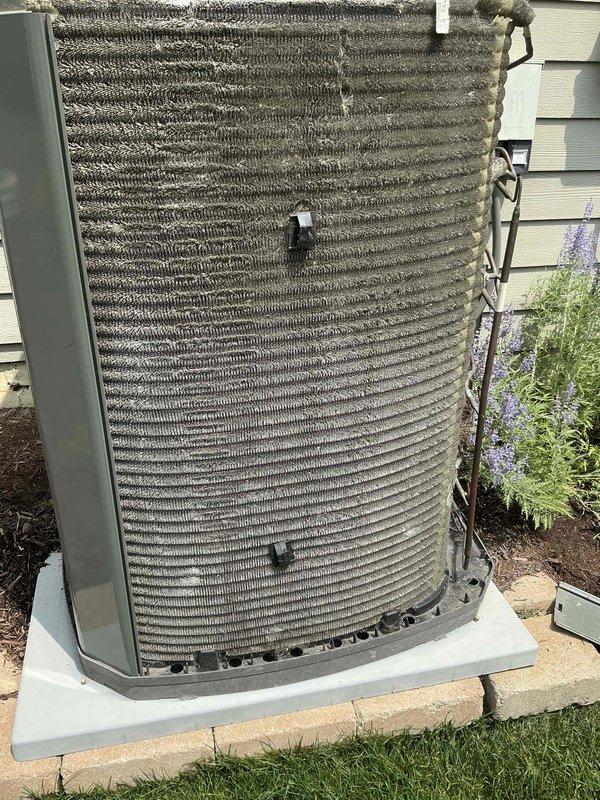 Completed comprehensive BFMA tune-up service on residential air conditioning system, including full inspection of outdoor condenser unit with corrugated heat exchanger coils and refrigerant line connections. Performed semi-annual filter change, replacing used filter media with fresh unit to maintain optimal airflow and system efficiency. All components inspected and found operating within normal parameters, with equipment confirmed in good working condition for continued seasonal operation.