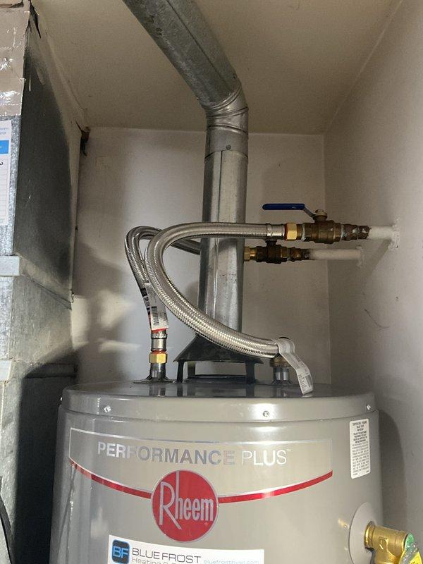 Responded to no hot water service call and performed comprehensive plumbing inspection as part of scheduled tune-up maintenance. Inspected Rheem Performance Plus water heater installation, including all connections, brass shut-off valves, flexible stainless steel supply lines, and galvanized exhaust venting system. All components found to be properly installed and functioning within normal parameters, with no visible corrosion or leaks detected at connection points.