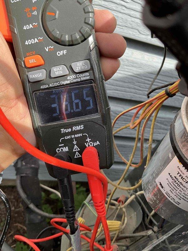 Completed comprehensive air conditioning tune-up on 12-year-old system. Performed electrical diagnostics using digital clamp meter to verify amperage draw and system performance, measuring motor run capacitor voltage ratings at 440/370VAC. All electrical components tested within normal operating parameters, system operating efficiently with no issues identified.