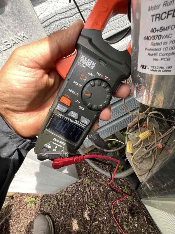 Completed comprehensive air conditioning tune-up on 12-year-old system. Performed electrical diagnostics using digital clamp meter to verify amperage draw and system performance, measuring motor run capacitor voltage ratings at 440/370VAC. All electrical components tested within normal operating parameters, system operating efficiently with no issues identified.