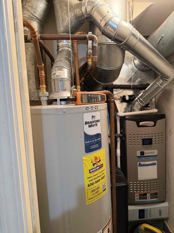 Performed tune-up service on Bradford White tanked water heater and identified incomplete combustion issues in the flue system. Observed sediment fallout from the water heater exhaust pipe indicating potential venting problems. Recommended comprehensive chimney inspection and combustion analysis using air advice diagnostics to determine proper venting function and ensure safe operation of the unit.