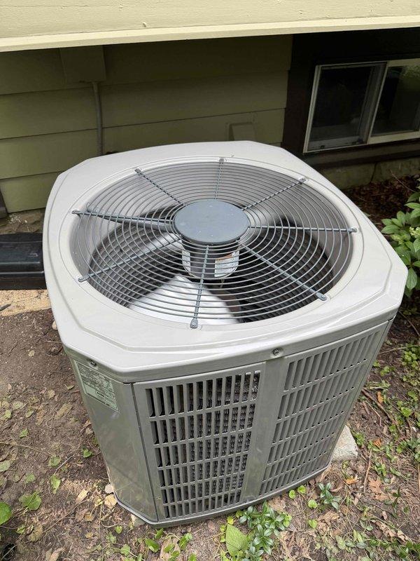 Responded to service call for outdoor condensing unit with previous technician concerns regarding potential refrigerant leak at compressor. Performed thorough inspection of compressor and surrounding components for refrigerant leaks using appropriate leak detection methods. Replaced failed dual capacitor with new unit from truck stock to restore proper motor operation. Installed hard start kit to assist compressor during startup and reduce electrical stress on the system. Verified all electrical connections secure and proper. Tested unit operation and confirmed system running within normal parameters with no refrigerant leaks detected at compressor or associated connections. Unit operating properly upon departure.