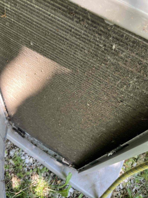Completed comprehensive BFMA tune-up on residential air conditioning system with equipment age of 1+ years. Performed standard maintenance protocol including system inspection, condenser coil cleaning to remove heavy accumulation of dust, dirt, pollen, and environmental debris that was restricting airflow through the fin array. Addressed significant soiling on lower and middle coil sections, restored proper heat transfer efficiency, and verified system operation. Unit showed typical weathering patterns consistent with outdoor exposure and benefited from thorough cleaning to optimize cooling performance.