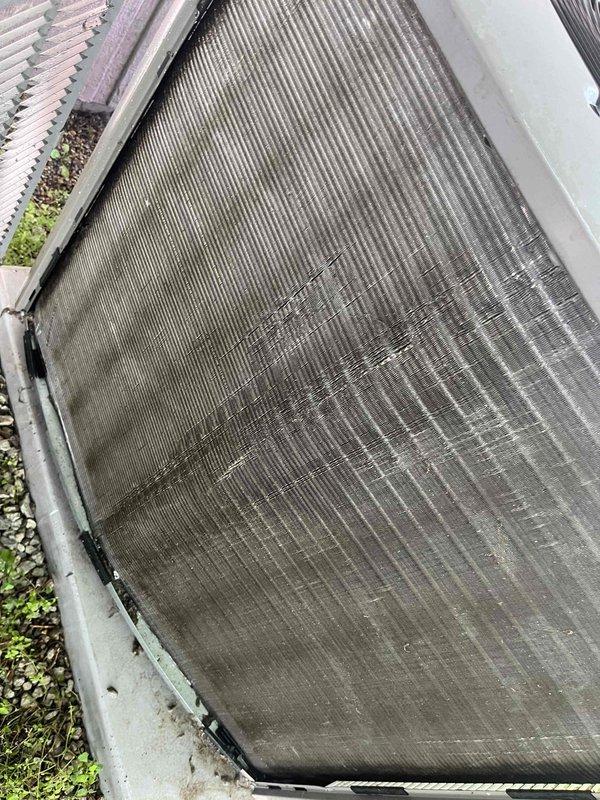 Completed comprehensive BFMA tune-up on residential air conditioning system with equipment age of 1+ years. Performed standard maintenance protocol including system inspection, condenser coil cleaning to remove heavy accumulation of dust, dirt, pollen, and environmental debris that was restricting airflow through the fin array. Addressed significant soiling on lower and middle coil sections, restored proper heat transfer efficiency, and verified system operation. Unit showed typical weathering patterns consistent with outdoor exposure and benefited from thorough cleaning to optimize cooling performance.