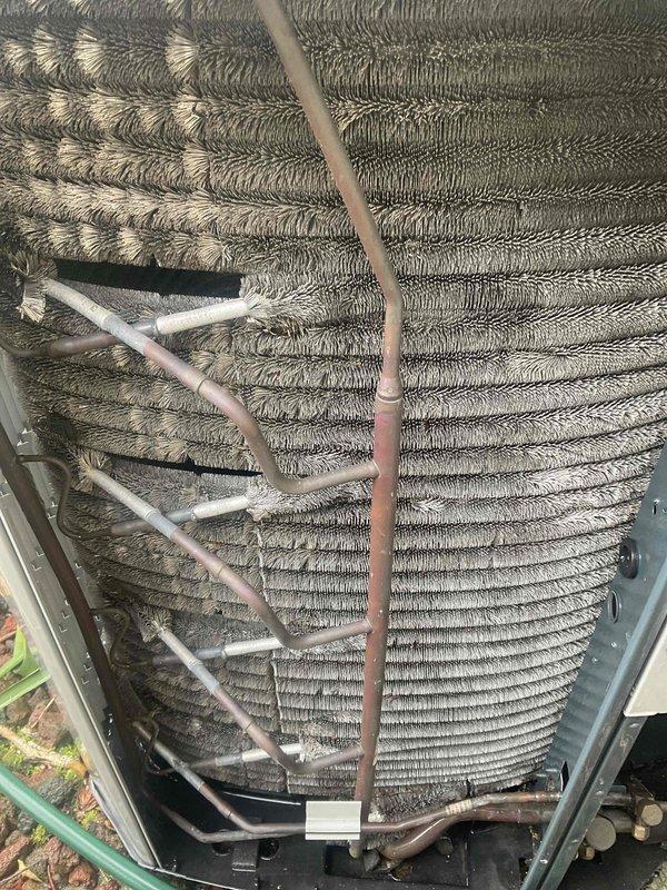 Completed comprehensive BFMA tune-up on a 9+ year old air conditioning system. Performed thorough inspection of outdoor condenser unit, including evaluation of evaporator coil condition with visible dust and debris accumulation on aluminum fins and copper refrigerant lines. Documented equipment condition through photography, noting normal operational wear patterns and environmental particle buildup on heat exchanger surfaces consistent with unit age and service history.