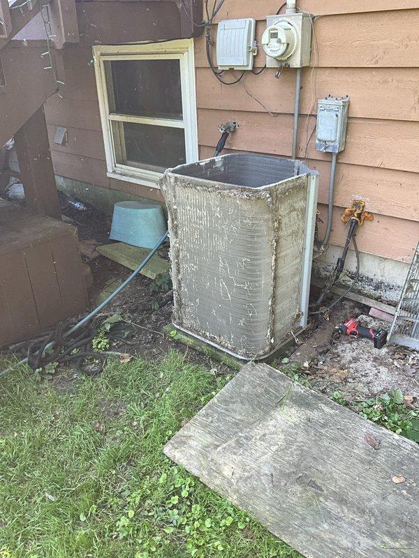 Completed comprehensive BFMA tune-up service on a 14-year-old air conditioning system during scheduled morning appointment. Performed thorough inspection of outdoor condensing unit, which exhibited significant weathering and exterior grime accumulation consistent with age and environmental exposure. Conducted detailed examination of internal components, noting substantial dirt and debris buildup within the unit base and on electrical connections. Cleaned condenser coils, removed accumulated debris from unit interior, and inspected all electrical connections including capacitor terminals and wiring. Verified proper refrigerant levels, tested system operation and airflow, and ensured all safety controls were functioning correctly. Unit returned to proper operating condition following standard preventive maintenance protocols.