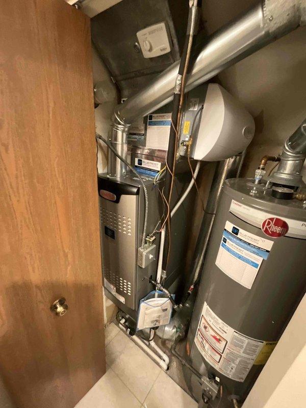 Completed furnace replacement installing a Lennox SL280MH downflow unit in a confined mechanical closet. Removed existing water heater to provide adequate workspace for the installation, with plumber scheduled to reinstall upon completion. Performed coil cleaning as part of the installation process to ensure optimal system performance and efficiency.