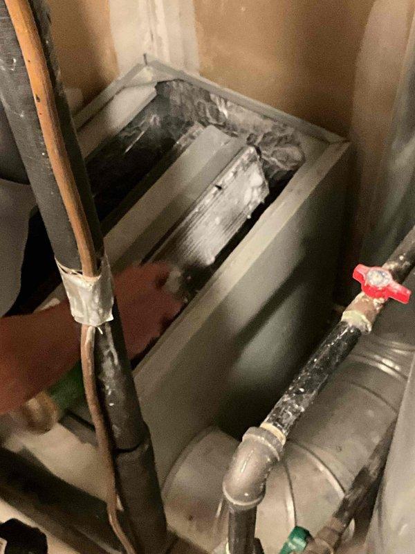 Completed furnace replacement installing a Lennox SL280MH downflow unit in a confined mechanical closet. Removed existing water heater to provide adequate workspace for the installation, with plumber scheduled to reinstall upon completion. Performed coil cleaning as part of the installation process to ensure optimal system performance and efficiency.