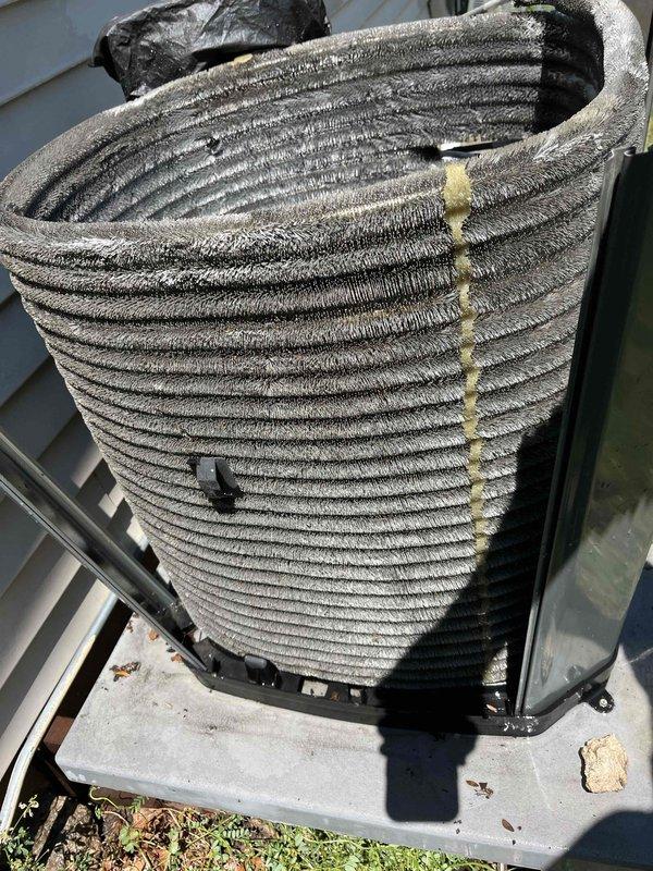 Completed comprehensive BFMA tune-up on 9-year-old air conditioning system and air cleaner unit. Performed thorough inspection and cleaning of outdoor condenser unit, which exhibited heavy accumulation of dust, dirt, and environmental debris on coil surfaces. Cleaned cylindrical coil assembly using appropriate methods to remove substantial buildup that was restricting airflow and reducing system efficiency. Inspected internal mechanical components including compressor, motor assembly, copper refrigerant lines, and associated fittings. Changed air cleaner filter as part of semi-annual maintenance service. Verified proper operation of fan motor and checked electrical connections. System restored to optimal operating condition with improved airflow through clean coil surfaces.