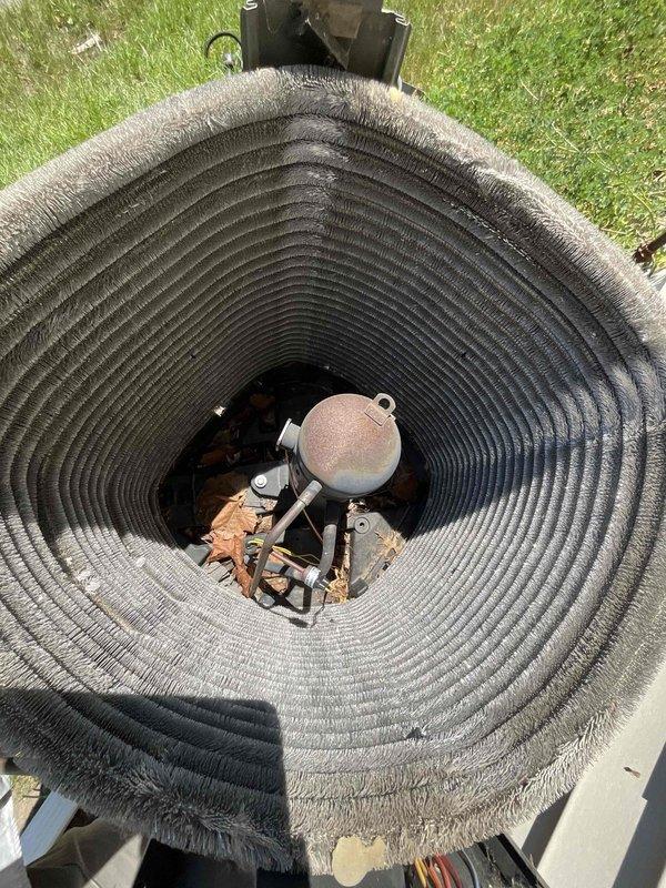 Completed comprehensive BFMA tune-up on 9-year-old air conditioning system and air cleaner unit. Performed thorough inspection and cleaning of outdoor condenser unit, which exhibited heavy accumulation of dust, dirt, and environmental debris on coil surfaces. Cleaned cylindrical coil assembly using appropriate methods to remove substantial buildup that was restricting airflow and reducing system efficiency. Inspected internal mechanical components including compressor, motor assembly, copper refrigerant lines, and associated fittings. Changed air cleaner filter as part of semi-annual maintenance service. Verified proper operation of fan motor and checked electrical connections. System restored to optimal operating condition with improved airflow through clean coil surfaces.