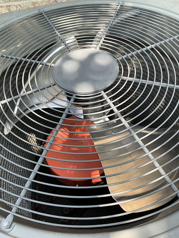 Replaced failed condenser fan motor, fan blade, and capacitor on outdoor heat pump unit. Removed old components, installed new OEM parts, and verified proper operation with successful unit startup and airflow test.