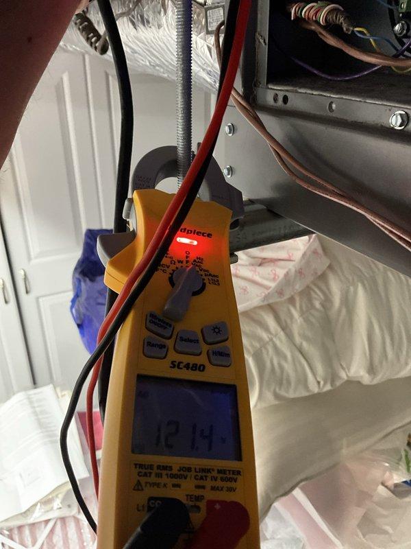Responded to service call for thermostat continuously rebooting during air conditioning operation. Previous surge protector installation did not resolve the issue. Performed comprehensive electrical diagnostics using multimeter, measuring 12.14 volts at critical system components. Upon inspection, discovered severely corroded evaporator coil with extensive white and gray mineral buildup throughout the heating element assembly. Corrosion had compromised system integrity, causing electrical irregularities that triggered thermostat reboot cycles specifically during cooling mode operation. Documented coil deterioration with photographic evidence showing chalky deposits on serpentine coils and connected refrigerant lines. Determined that electrical instability was caused by failing evaporator coil rather than power supply issues. Recommended and sold evaporator coil replacement to resolve intermittent thermostat malfunction and restore proper system operation.