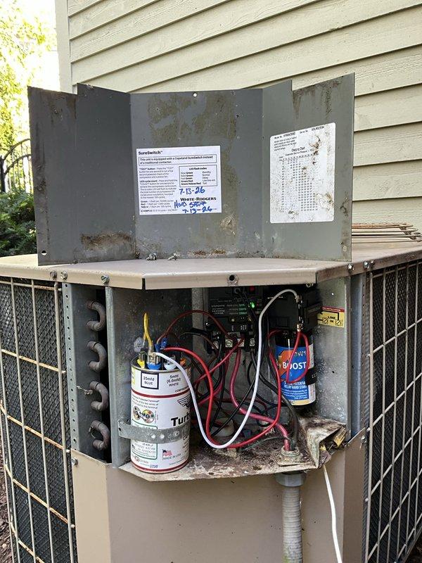 Completed capacitor replacement on AC unit #2, a newer Carrier system. The failed dual-run capacitor (45/5 MFD, 370VAC) was removed and replaced with a new OEM-spec component to restore proper compressor and condenser fan motor operation. Unit tested successfully following repair with normal amperage draws and proper cooling cycle confirmed.