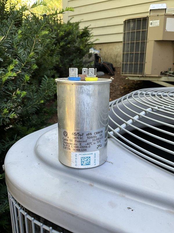 Completed capacitor replacement on AC unit #2, a newer Carrier system. The failed dual-run capacitor (45/5 MFD, 370VAC) was removed and replaced with a new OEM-spec component to restore proper compressor and condenser fan motor operation. Unit tested successfully following repair with normal amperage draws and proper cooling cycle confirmed.