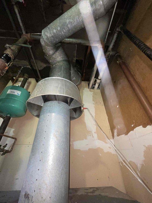Conducted on-site assessment of existing boiler system and mechanical room infrastructure for equipment replacement estimate. Evaluated current heating system configuration including vertical flue venting, ductwork connections, expansion tank, and associated piping network to determine scope of work and equipment specifications required for new boiler installation.